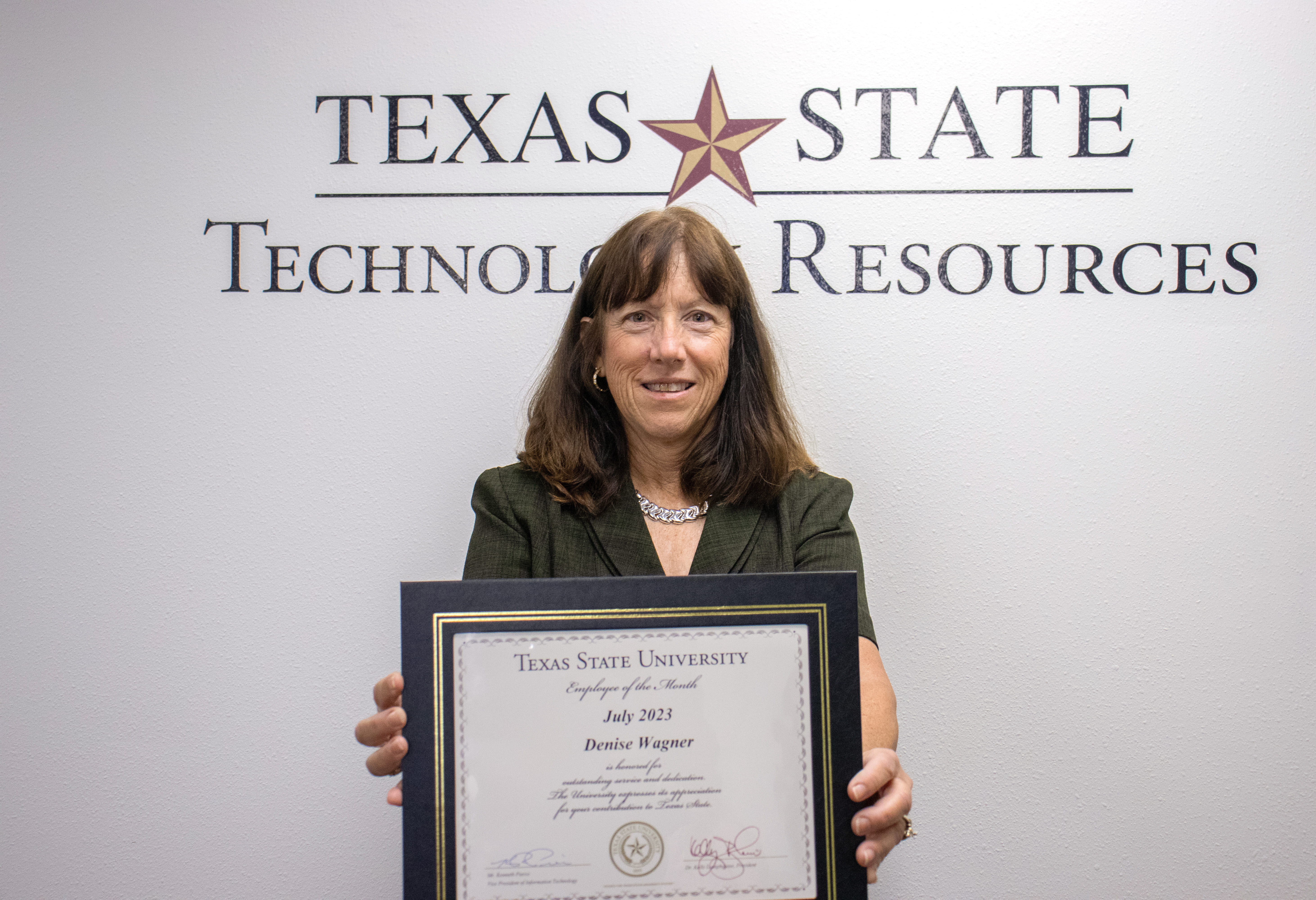 Denise Wagner holding a certificate