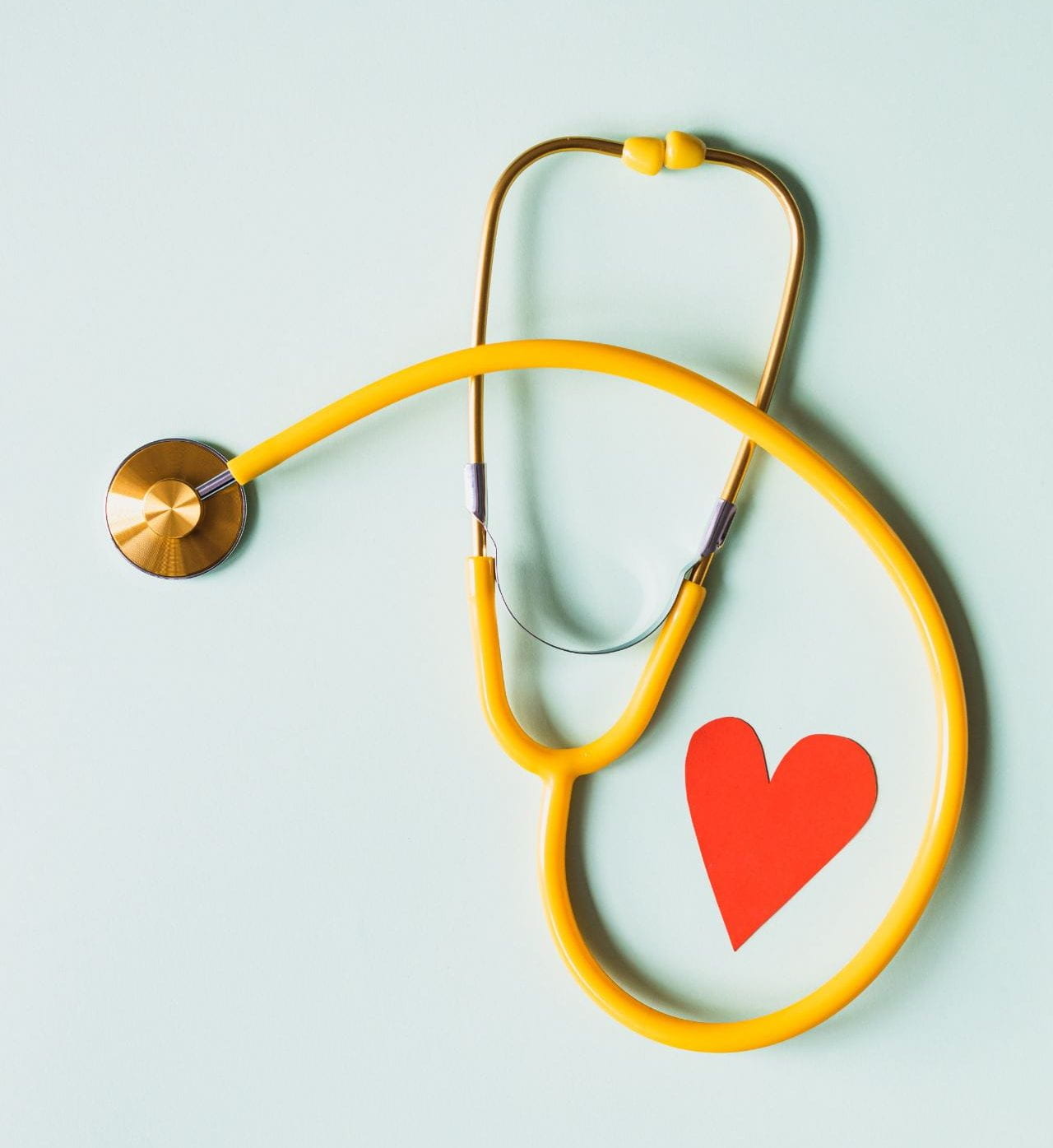 a stethoscope and a red paper heart